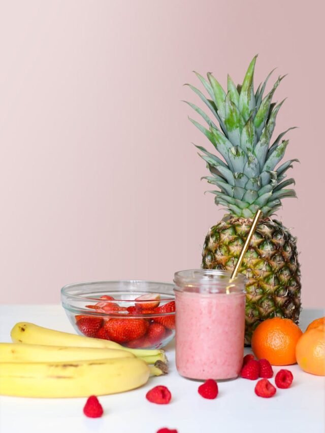 A vibrant smoothie with pineapple, banana, and berries, showcasing healthy freshness.